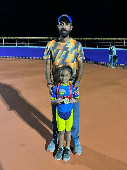 Proud father and coach. Standing with my daughter and her medal after a great performance. We teach kids to be proud of their efforts, no matter the result.