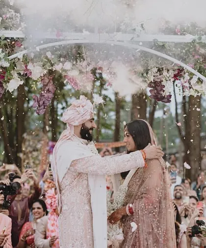The magical Jaimala moment under a floral arch, with a shower of petals. This is a pinnacle moment of the ceremony, and we capture it with all its emotion and beauty.