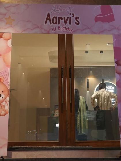 This custom-printed entrance arch was designed for a teddy bear themed first birthday. The soft pink colors and cute graphics create a sweet and personal welcome for the little one's party.