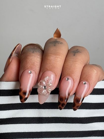 A close-up on the 3D flower and tortoiseshell tip. I love mixing different styles like animal print and florals to create a manicure that is unexpected and chic.