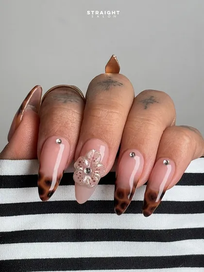 A close-up on the 3D flower and tortoiseshell tip. I love mixing different styles like animal print and florals to create a manicure that is unexpected and chic.