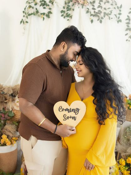 An intimate couple's portrait with a "Coming Soon" sign. Their closeness and gentle smiles make this a sweet and romantic announcement.