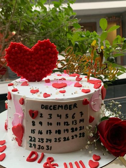 A romantic anniversary cake with a calendar marking the special date.