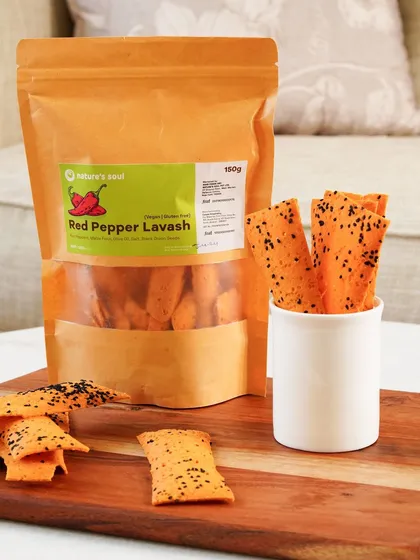 A product-focused shot of the red pepper lavash, with the packaging clearly visible and the crackers displayed invitingly.