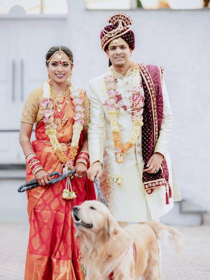 A formal family portrait with a twist. The couple stands proudly with their dog, showing that family comes in all forms.