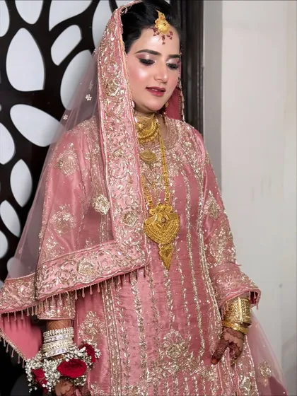 A full-length view of the stunning pink embroidered suit, showing how the makeup and outfit come together for a complete look.