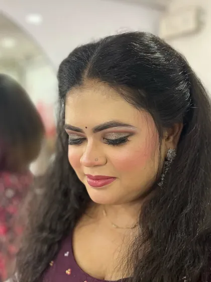A close-up with eyes closed to showcase the soft, shimmery eyeshadow. This kind of detail is perfect for a glamorous evening look.