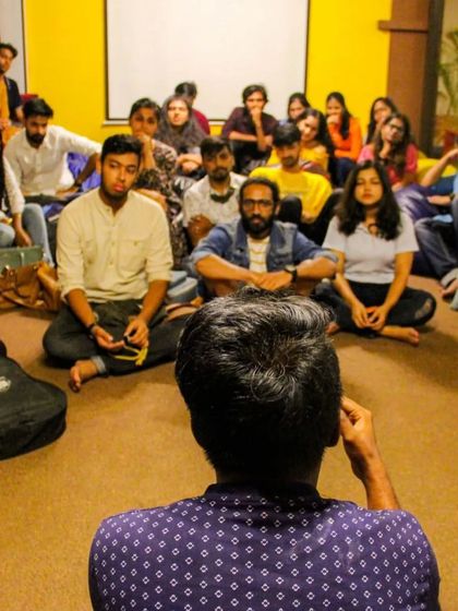 A poet shares their work at a 'Rubaiyat' event, a platform that encourages poetry for a change. My space is proud to host artists who use their voice to make an impact.