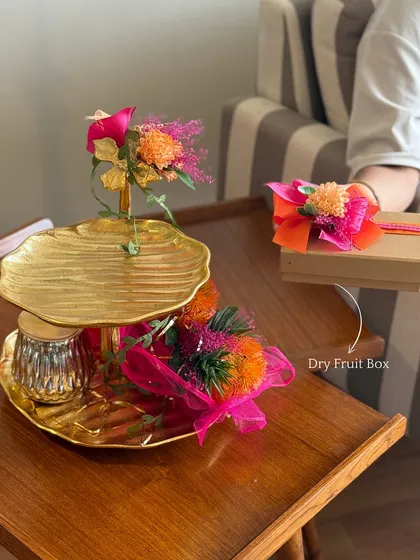 Here, we show the versatility of our festive hampers. The dry fruit box can be removed, leaving a stunning golden platter ready for serving, making our gifts both thoughtful and practical.