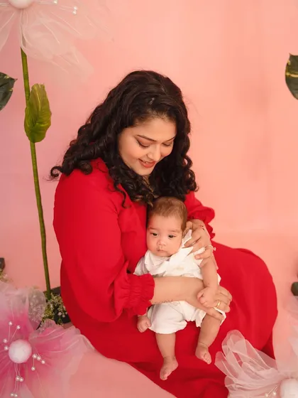 A new mother gently cradles her baby during our Mother's Day minis. This photo captures the peaceful, loving bond in those early months of motherhood.