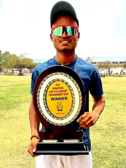 Karan Mishra with his winner's trophy from the U-19 tournament.