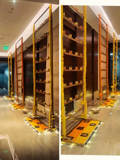 We created these decorative installations in the office hallway, using shelves filled with diyas and framed by marigold garlands to create an immersive and festive pathway for employees.