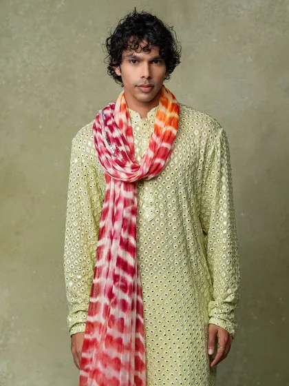 A menswear lookbook image showcasing a kurta styled with a colorful scarf. This demonstrates to customers how items can be accessorized, adding value to the shopping experience.