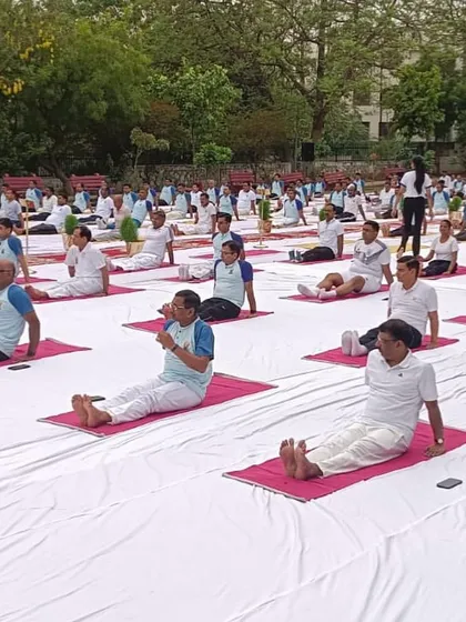 A large group of participants practicing a seated forward bend during our Delhi event. The uniformity of the practice creates a beautiful visual of collective mindfulness.
