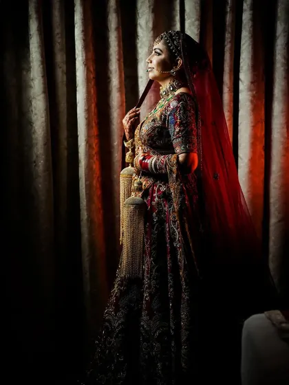 A moody and artistic portrait of the bride, using shadows and a single light source.