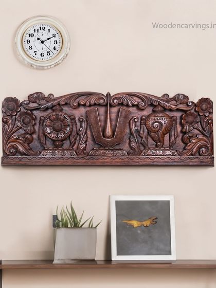 This 36-inch wall panel features the auspicious Balaji Thirunamam, flanked by the Sudarshana Chakra and Panchajanya shankha, finished in a rich wax brown.