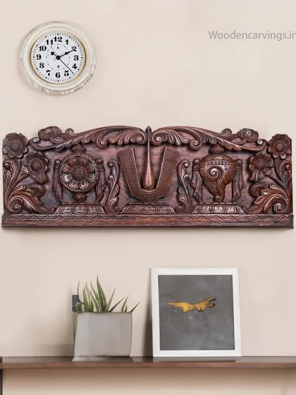 A 36-inch wall panel featuring the auspicious symbols of Lord Balaji: the Thirunamam, Shankha (conch), and Chakra (discus). This is a classic decorative piece for devotees, often placed above an entrance.