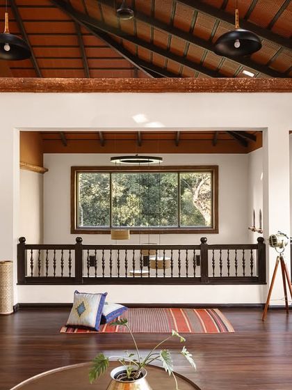 The mezzanine lounge offers a different perspective, looking out over the main living area. The design uses open railings and connected volumes to ensure that even separate spaces feel part of a cohesive, flowing whole, encouraging connection.