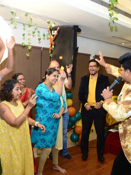 A group of guests enjoying an interactive game at a private celebration. My focus is on creating a lively atmosphere where everyone feels comfortable joining in.
