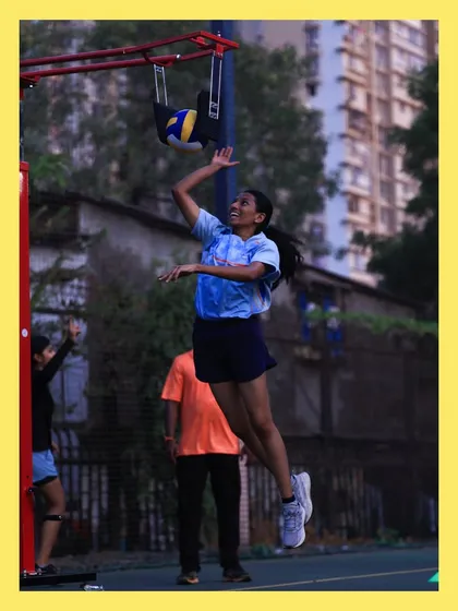 A young spiker practices her arm swing and jump using our specialized equipment. This tool helps players develop power and accuracy safely.