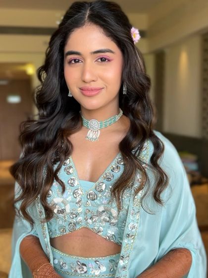 A smiling portrait of Serena, her Haldi makeup looking fresh and radiant.