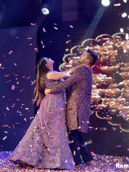 A joyful moment on the dance floor as the couple is showered with confetti during their engagement celebration.