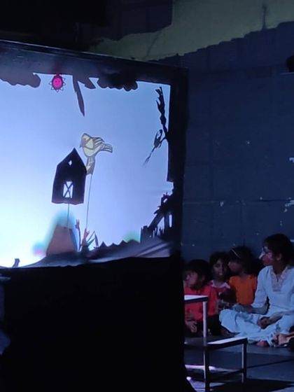 A behind the scenes look at our shadow puppetry segment. The children are completely engrossed as they operate the puppets they created, learning about visual storytelling in a unique and engaging way.