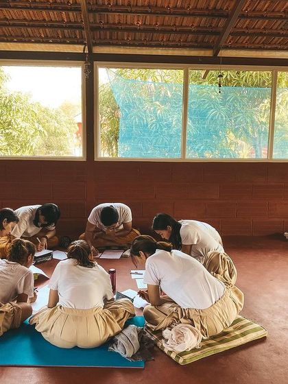 Students gather in a circle for a study session, sharing notes and discussing concepts. Collaborative learning is a big part of the ashram experience; we grow by supporting each other's understanding.