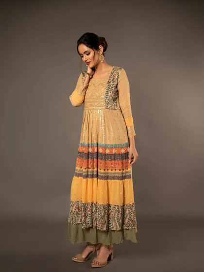 A side-profile shot that captures the length and flow of the layered dress, useful for showing the garment's proportions.