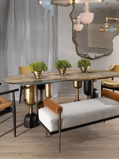 The Dining Bench from our Koko collection merges functionality with artistic design. The combination of soft bouclé fabric, solid teak wood trim, and intricately cast brass legs in a twisted fabric pattern creates a piece that is both comfortable and a true conversation starter.