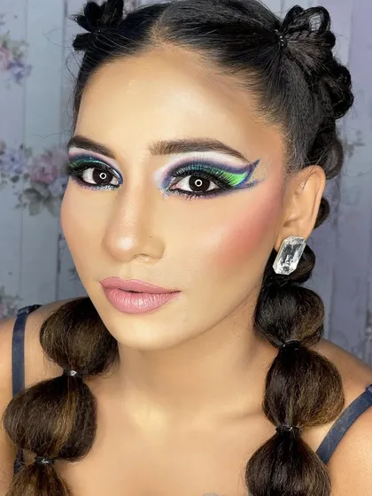 A front-facing view of a similar creative look, this time with green and purple tones.
