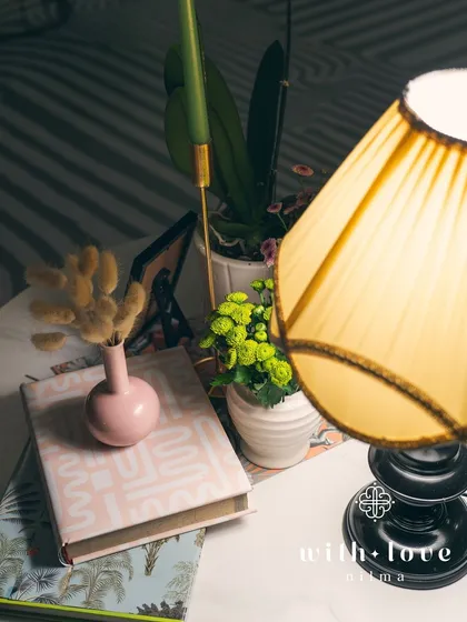 As evening falls, the custom lampshades in 'The Conservatory' cast a warm, inviting glow on the detailed decor.