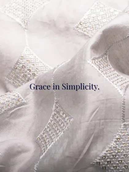 Grace in simplicity. This image showcases the delicate, geometric embroidery and sequin work on a fine white fabric, highlighting my focus on understated yet impactful details.