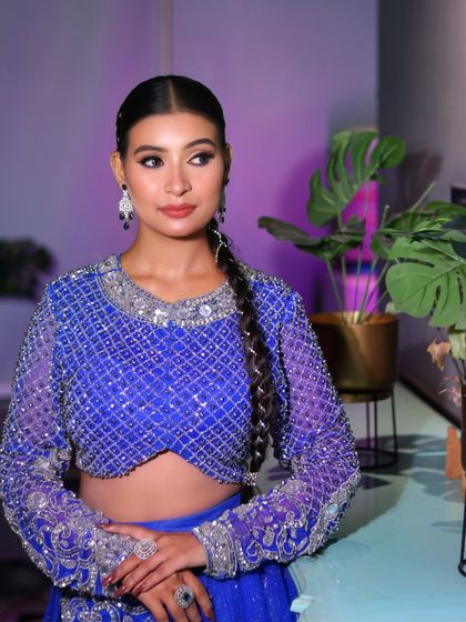 The full look, showing the balance between the intricate outfit and the sophisticated, understated makeup.