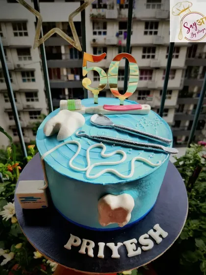 A sweet treat for the professional who fixes sweet tooths. This dentist-themed cake for a 50th birthday includes edible fondant teeth, dental tools, and floss, a fun nod to the recipient's profession.