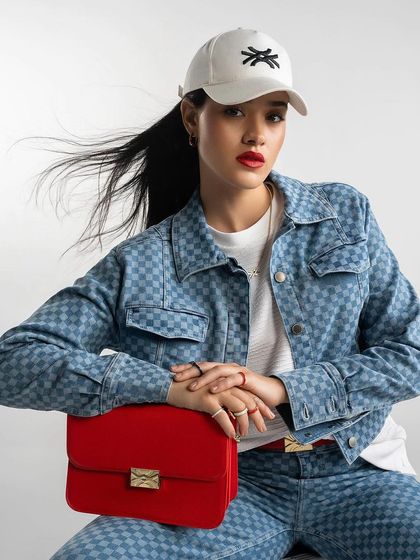 A denim-on-denim look from Benetton, styled with a pop of red for a modern, chic campaign image.
