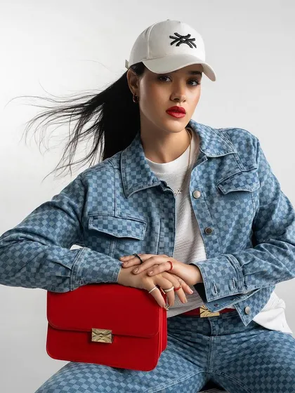 A denim-on-denim look from Benetton, styled with a pop of red for a modern, chic campaign image.