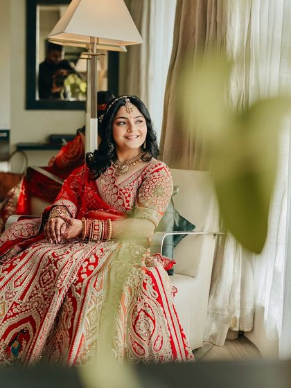 A candid moment of Shikha looking serene and happy. Her soft, natural makeup ensures she looks like herself, just more radiant, on her wedding day.