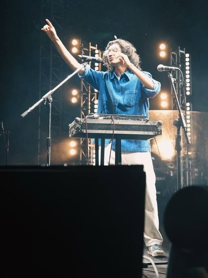 An artist interacting with the crowd from the stage. My focus is on creating an intimate connection between the performer and the audience, no matter the size of the venue.