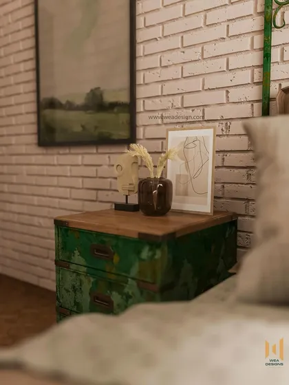 A close-up of the distressed green bedside table, which adds a pop of color and vintage character to the room.