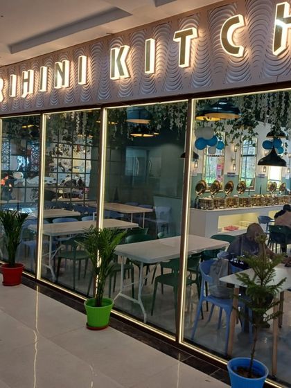 The storefront of our restaurant, with the "Grihini Kitchen" sign brightly lit. A welcoming entrance for all our guests.