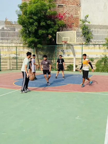 A group of players engaged in a dynamic warm-up before practice begins.