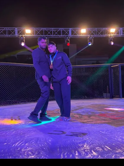 A coach and fighter celebrating a win at Elite Combat MMA. This moment captures the pride and partnership that defines our team.
