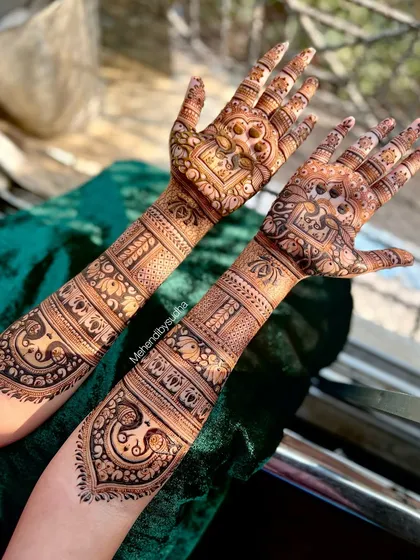 The back of the hands for an engagement mehendi, featuring elegant paisley and floral patterns.