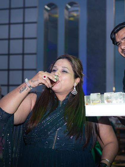 The same moment from a slightly different angle, capturing the guest's enjoyment and the bartender's friendly demeanor. I pride myself on having an approachable and entertaining team.