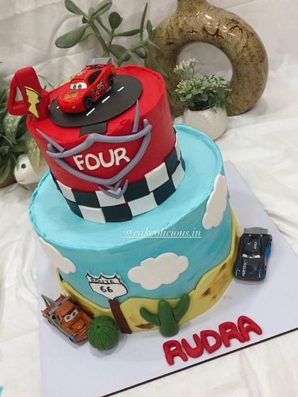 This angle shows the details of the Route 66 sign and the checkered flag pattern on the ganache cake.