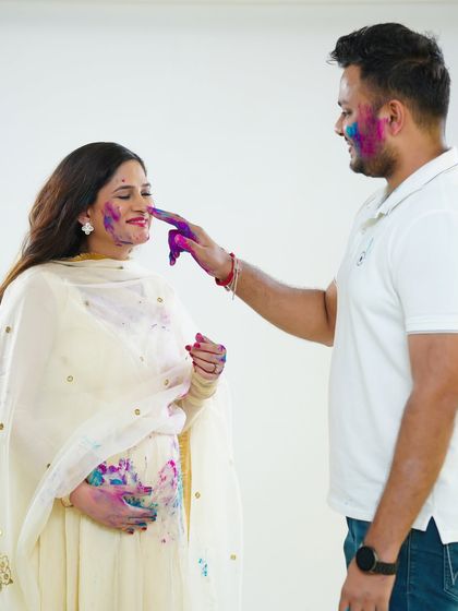 Capturing the playful interactions is what makes this theme so special. Here, the father-to-be gently dabs color on his partner's nose, a moment of pure, unscripted fun.