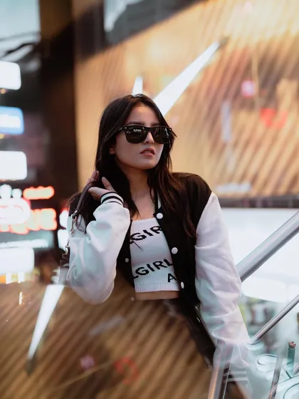 For influencers and brands, I create content that stands out. This night shoot uses the ambient light of city signs to create a cool, modern vibe perfect for a street style portfolio.