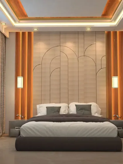 This bedroom design showcases an arched, paneled headboard that adds an architectural element to the space. The warm wood tones and recessed ceiling lights create a cozy and sophisticated atmosphere.