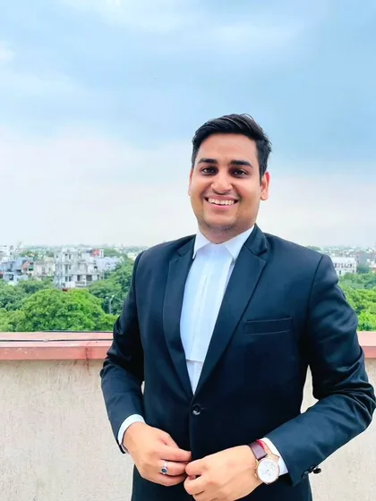 A professional portrait taken outdoors. As your advocate, I believe in presenting a confident and approachable front, ready to stand up for you.